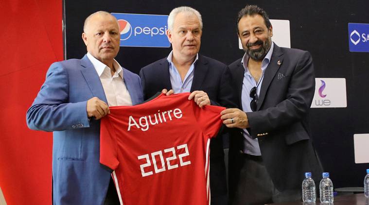 Javier Aguirre, the newly named coach for Egypt national soccer team, holds a jersey reading 2022 with Egyptian FA head Hany Abo Rida and member of Egypt FA, Magdy Abdelghany in Cairo