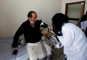 A volunteer nurse checks a patient at a charitable medical center which is offering free medical services to support those in need in Sanaa