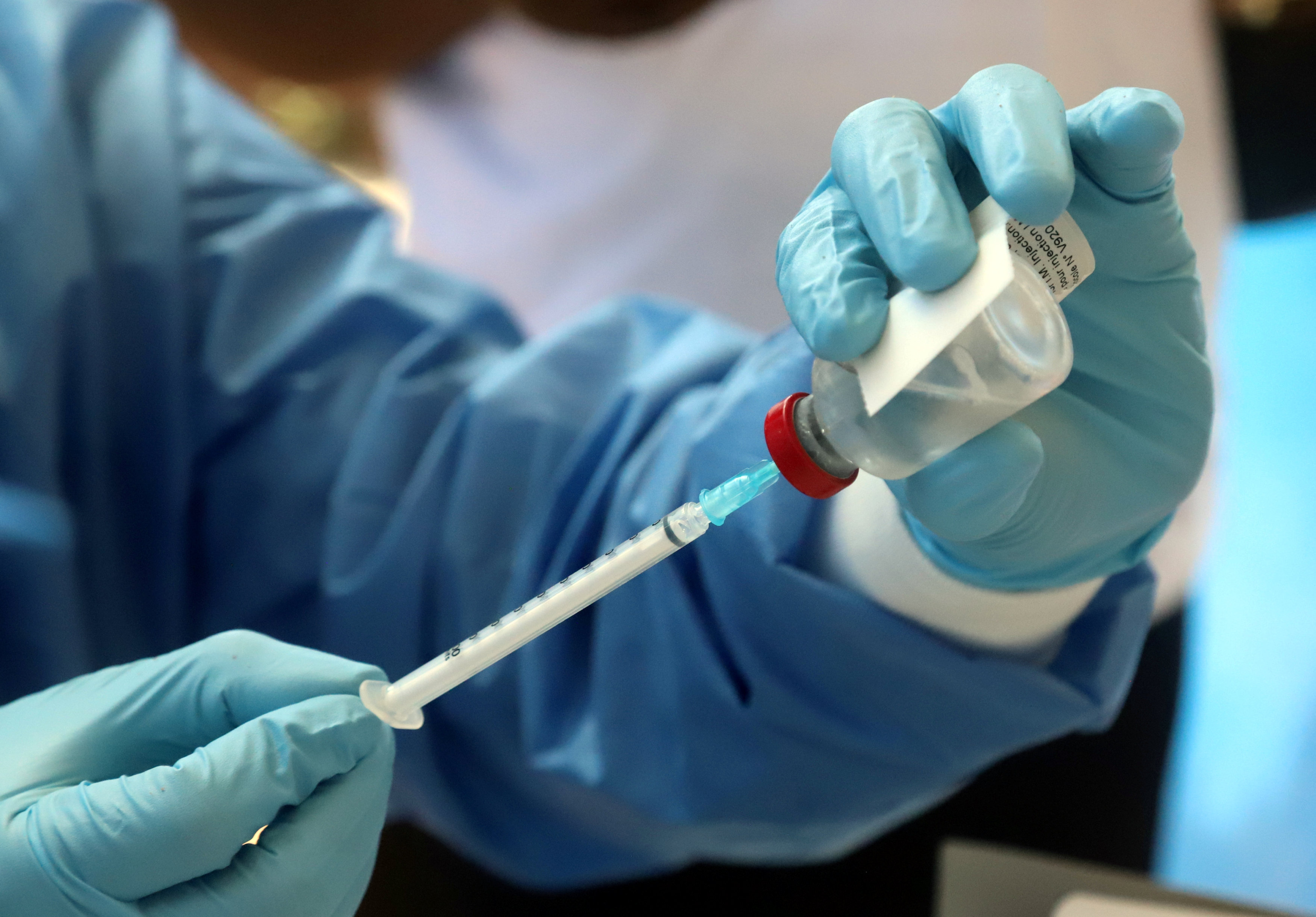 A World Health Organization worker prepares to administer a vaccination during the launch of a campaign aimed at beating an outbreak of Ebola in the port city of Mbandaka
