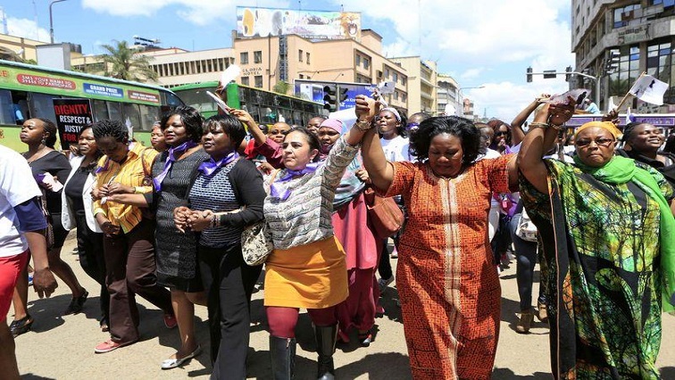 Women take part in a protest along a main street in the Kenyan capital of Nairobi
